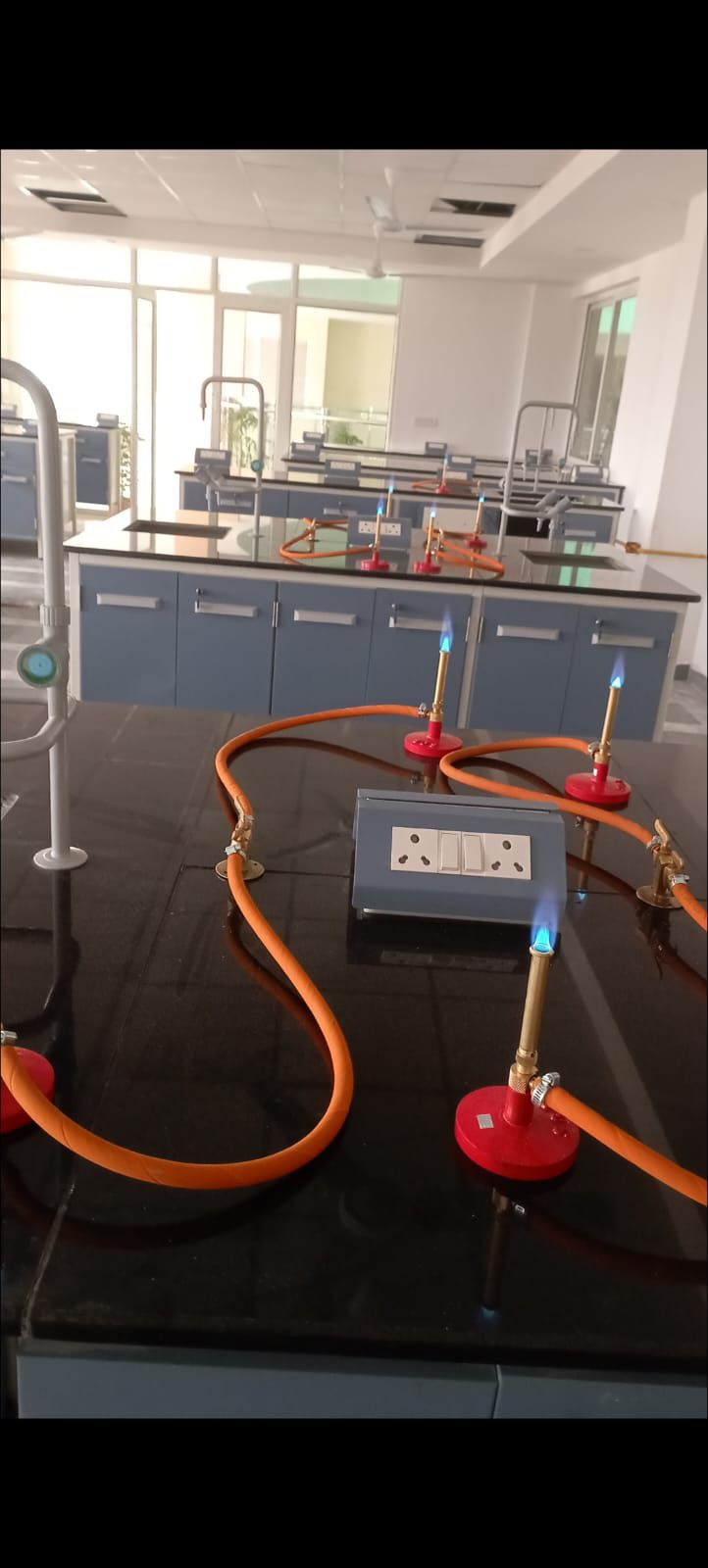 Laboratory gas supply system with lit Bunsen burners installed at research facility